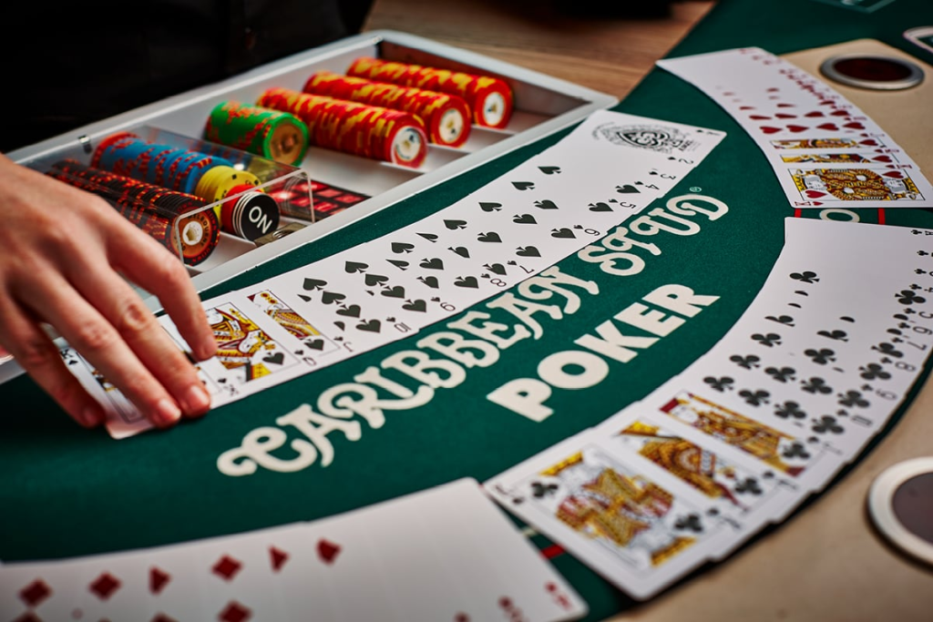 Caribbean stud poker table with chips and cards.